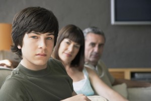 Boy sitting with parents
